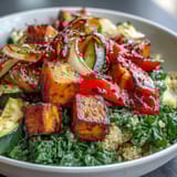 Forkful of the Warm Salad Bowl featuring roasted sweet potato, quinoa, and wilted spinach, drizzled with a warm vinaigrette.