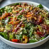 A vibrant and nutrient-packed Rainbow Salad Bowl, featuring crunchy nuts, seeds, and a medley of fresh veggies, perfect for lunch or dinner.  