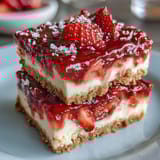 Bright pink strawberry lemon filling on golden shortbread crust, perfect for summer picnics and potlucks.  