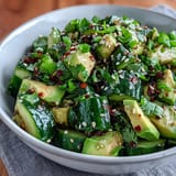 Fresh smashed cucumber and avocado salad with sesame, a zesty, cool dish.