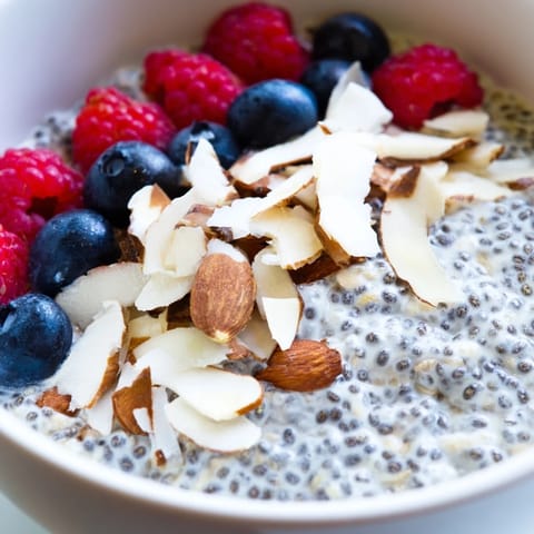 Creamy layered Poppy Seed Chia Pudding with toasted almonds and coconut for a healthy breakfast.  