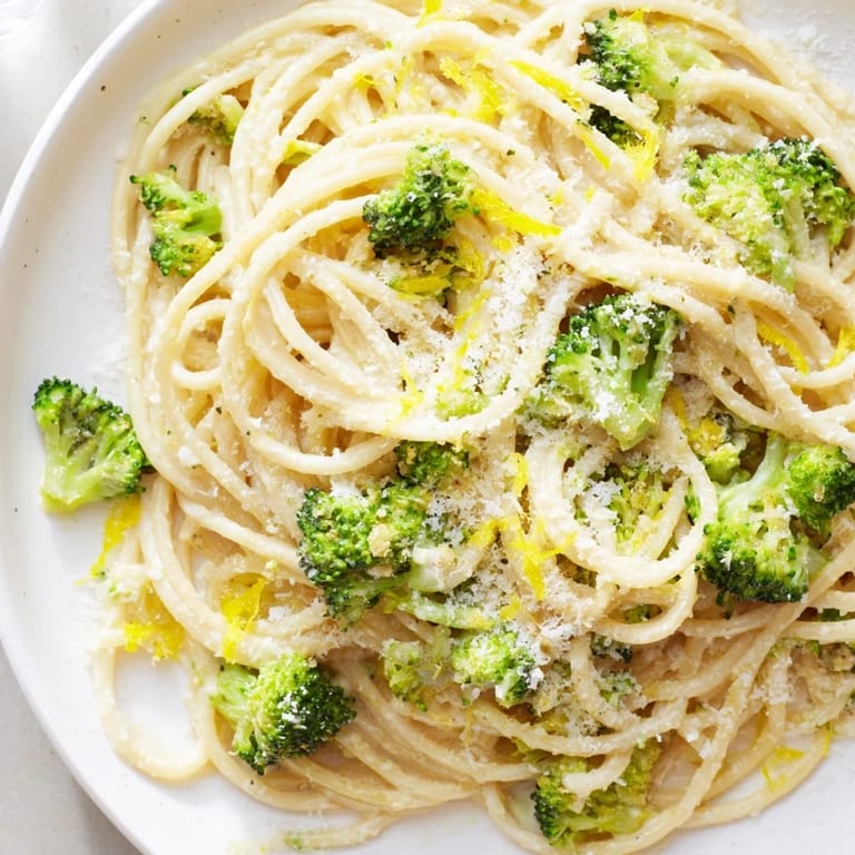 Savory One-Pot Lemon Broccoli Pasta served steaming in a rustic bowl, garnished with fresh parsley and extra Parmesan for a comforting Italian-inspired meal.  