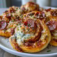 Golden, flaky pastry spirals filled with zesty marinara, melted mozzarella, and savory pepperoni. Perfect as a snack, appetizer, or party treat.